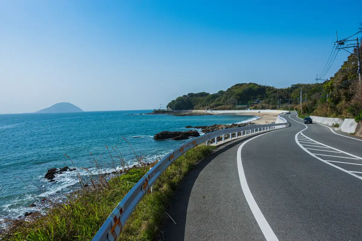Collect your motorcycle at Fukuoka Airport, visit Yūtoku Inari Shrine, ride the sea wall road across Isahaya Bay and cross the Unzen mountains to the coast.