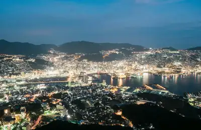 An ocean ferry ride, volcanic ruins, vibrant Nagasaki, and a mountaintop ropeway nightscape.