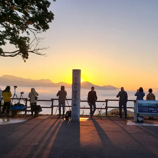 Travelers enjoying a sunset at Takachiho Town Kunimigaoka