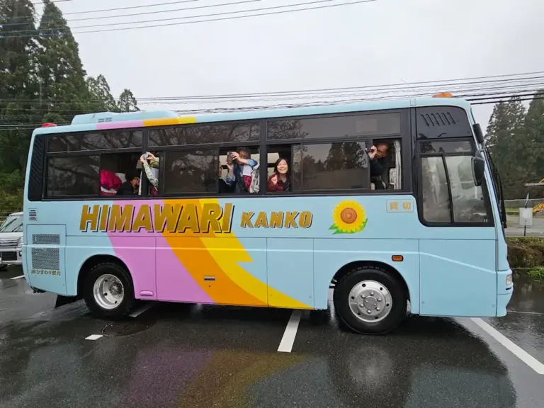 tour bus preparing to depart on a rainy day